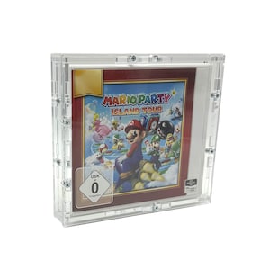 May include: A clear plastic case with a red and gold video game cartridge inside. The game is Mario Party Island Tour. The case has a USK rating of 0.