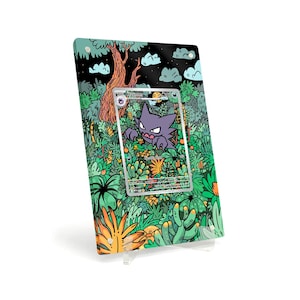 May include: A framed artwork featuring a Haunter Pokémon card set against a vibrant, illustrated jungle backdrop. The artwork includes a tree, clouds, and various plants in shades of green, orange, and black. The card is in a silver frame.