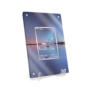 May include: A rectangular acrylic display featuring a card with a scenic illustration of a person and a starry sky. The card is centered within the acrylic, held in place by small silver screws. The display is supported by a clear plastic stand.
