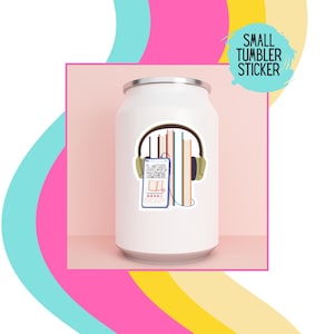 May include: White tumbler with a sticker of a phone with headphones and a stack of books. The sticker says "Digital Download".