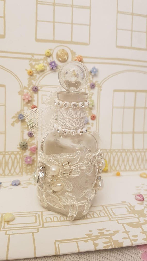 A genuinely atmospheric handmade glass apothecary bottle with lace detail and a stopper — the kind of cottagecore vanity piece that looks like it escaped a Victorian cabinet of curiosities.