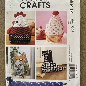 May include: A McCall's Crafts sewing pattern envelope M6414 featuring illustrations of four fabric projects: a chicken, a cupcake, an owl, and a dog. The envelope includes the text McCall's Crafts, M6414, and Size OSZ with a barcode on the side.