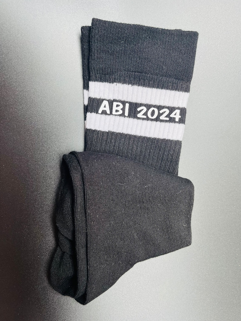 May include: Black socks with white stripes and the text "ABI 2024" in white.