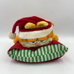 Christmas Garfield Cat Vintage Retro Soft Plush Toy laying on Pillow made by Dakin from 1980s TV Show 1978-1981, United Feature Syndicate