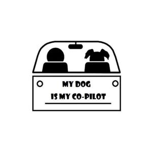 May include: Black and white silhouette of a car with a person and a dog inside. The car has a sign that reads "My dog is my co-pilot."