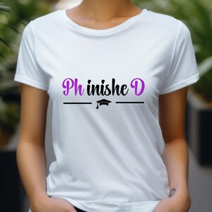 May include: White t-shirt with the text "Ph inishe D" in purple and black lettering, with a graduation cap icon underneath.