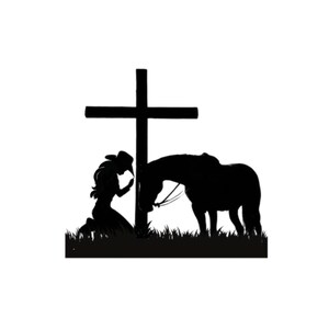 May include: Silhouette of a woman kneeling in prayer with a horse beside her, both facing a wooden cross.