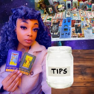 May include: A woman holding two tarot cards, with a glass jar labelled "TIPS" in the foreground. A table in the background displays numerous tarot cards and decorative items. The scene is set against a cosmic backdrop.