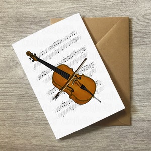 May include: A white card with a brown cello and bow on top of musical sheet music. The cello is brown with a black neck and black strings. The bow is brown with black hair. The musical sheet music is black and white.