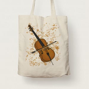 May include: A beige tote bag featuring a printed design of a brown and black cello and bow. The cello is surrounded by brown paint splatters.