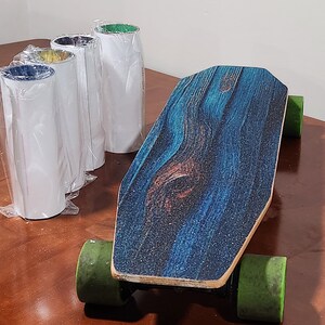 May include: A blue and brown electric skateboard with green wheels. The skateboard has a wood grain pattern on the deck.