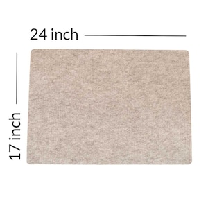 May include: A beige rectangular rug measuring 24 inches by 17 inches. The rug has a textured surface.