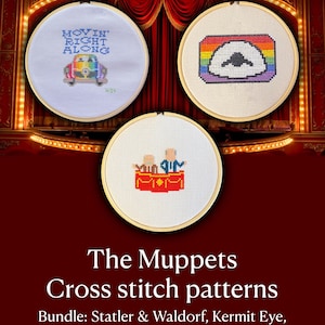 May include: Three circular wooden embroidery hoops containing cross-stitch designs. One features a rainbow-colored car with the text "MOVIN' RIGHT ALONG". Another shows a rainbow-bordered eye. The third depicts two figures in a red theater balcony.