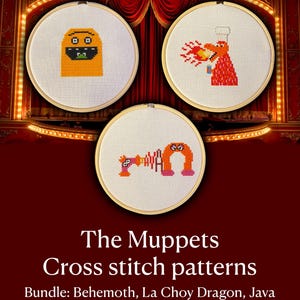 May include: Three circular wooden embroidery hoops containing cross stitch patterns of Muppet characters. The top left shows a yellow creature, the top right a red dragon breathing fire, and the bottom center features the text "JAVA" in colorful letters.