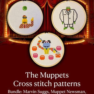 May include: Three circular wooden embroidery hoops containing cross stitch patterns of Muppets characters. The designs feature Marvin Suggs with colorful spheres, the Muppet Newsman in a white suit, and a character juggling various small objects.