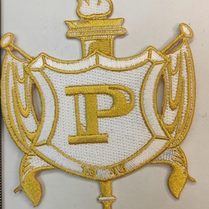 May include: A gold and white embroidered patch with a large letter "P" in the center, surrounded by a white shield with gold trim. The shield is flanked by two gold scrolls with a gold torch at the top.