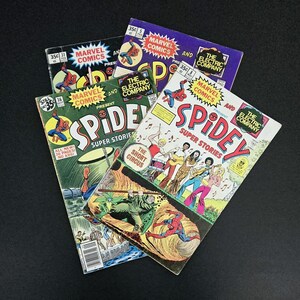 May include: Three vintage comic books featuring Spider-Man. The covers are all red, white, and blue with the title "SPIDEY" in large, yellow letters. The comics are from Marvel Comics and The Electric Company.
