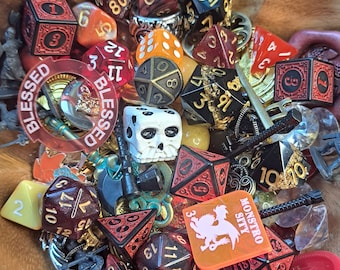 May include: A wooden bowl filled with a variety of dice, including a skull-shaped die, a red die with the word "MONSTRO SITY" on it, and a red die with the number "10" on it. There are also several other dice, some with numbers and some with symbols.
