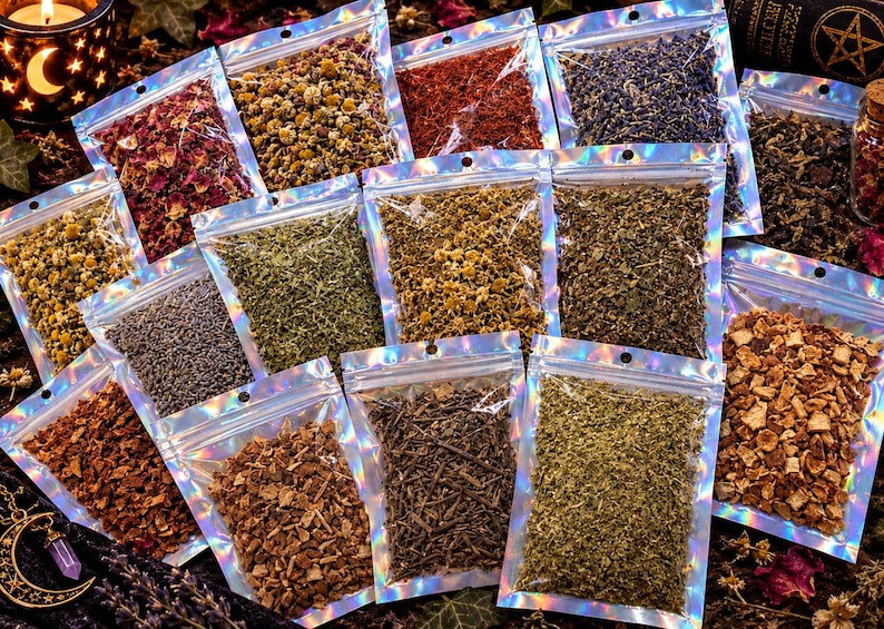 May include: A collection of small, clear holographic zip-lock pouches filled with various dried herbs, flowers, and botanical ingredients, including red rose petals, yellow chamomile, purple lavender, green leaves, and brown bark pieces.