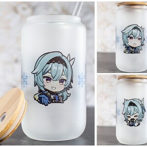 May include: A frosted glass tumbler with a bamboo lid and straw. The tumbler features a cartoon image of a female anime character with blue hair and a blue and white outfit. The character is surrounded by snowflakes.