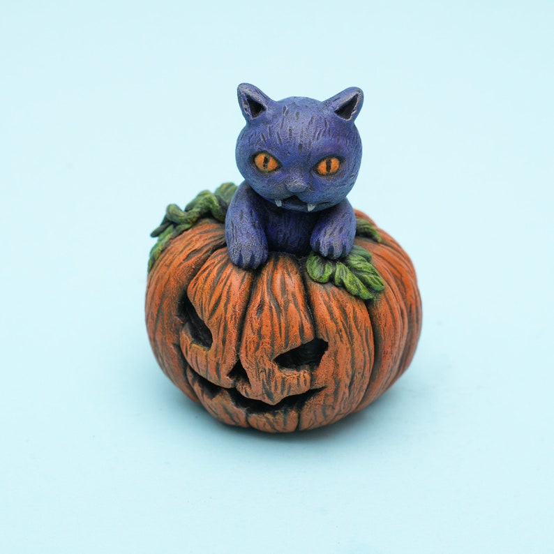 Grumpy Purple Cat Sitting in Halloween Pumpkin With Leaves. Colorful