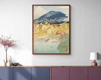 May include: A vintage Japanese woodblock print depicting a mountain landscape with a lake in the foreground. The mountain is blue and green, and the lake is a light blue. The trees are a mix of green, yellow, and orange.