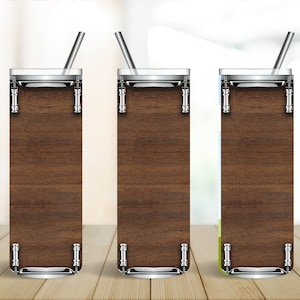May include: Three tall, clear glass tumblers with stainless steel lids and straws. Each tumbler features a wood grain design.