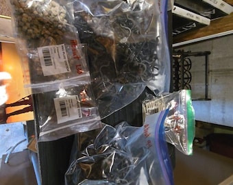 May include: A collection of Pro Plug System fasteners and components contained in several clear plastic bags. The bags hold various small hardware pieces, including screws and plugs, with some labels indicating the product name and color.
