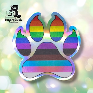 May include: A holographic paw print sticker with a rainbow design. The paw print is in the shape of a dog's paw, with each toe and pad section featuring a different color of the rainbow. The sticker has a shiny, iridescent finish.