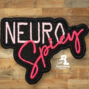 May include: Black embroidered patch with pink and red lettering that reads "Neuro Spicy".