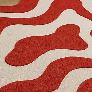 Hand-tufted bold red and white abstract rug with irregular amoeba shape and sculptural wavy layers. Modern retro design perfect for living rooms, bedrooms, or artistic spaces. Handmade custom wool rug adds visual interest and a fun pop of color to minimalist or boho interiors. Soft, cozy, and durable area rug ideal for under coffee tables or sofas. Unique sculpted carpet designed to elevate home decor with a bold and stylish statement.