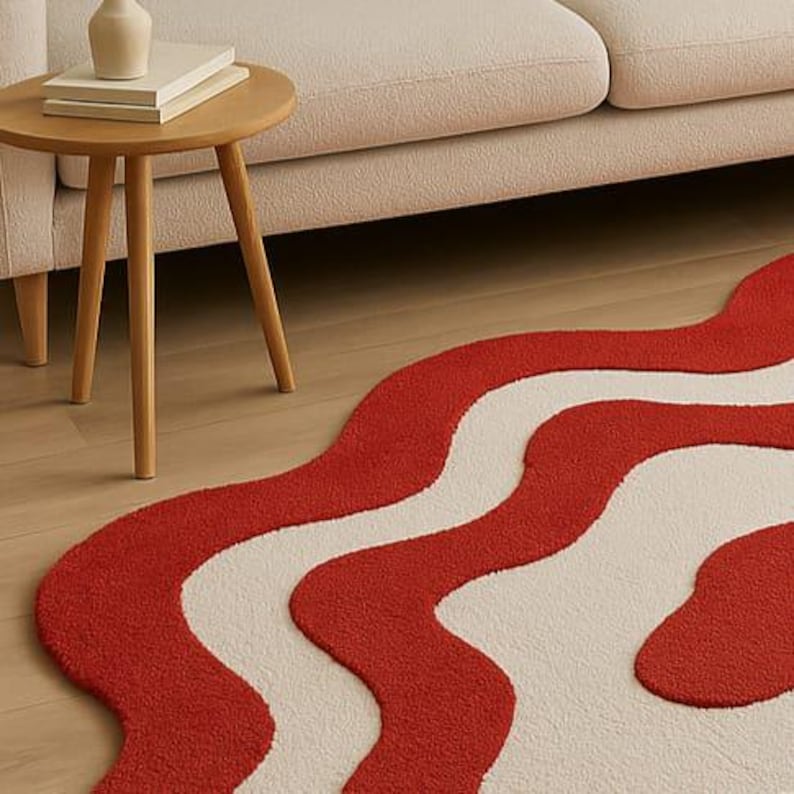 Hand-tufted bold red and white abstract rug with irregular amoeba shape and sculptural wavy layers. Modern retro design perfect for living rooms, bedrooms, or artistic spaces. Handmade custom wool rug adds visual interest and a fun pop of color to minimalist or boho interiors. Soft, cozy, and durable area rug ideal for under coffee tables or sofas. Unique sculpted carpet designed to elevate home decor with a bold and stylish statement.
