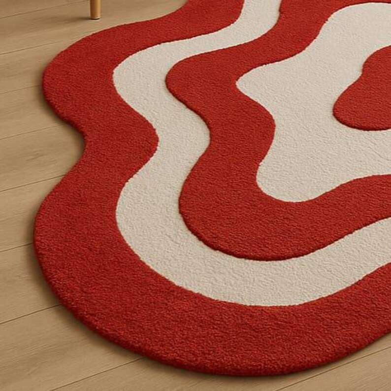 Hand-tufted bold red and white abstract rug with irregular amoeba shape and sculptural wavy layers. Modern retro design perfect for living rooms, bedrooms, or artistic spaces. Handmade custom wool rug adds visual interest and a fun pop of color to minimalist or boho interiors. Soft, cozy, and durable area rug ideal for under coffee tables or sofas. Unique sculpted carpet designed to elevate home decor with a bold and stylish statement.