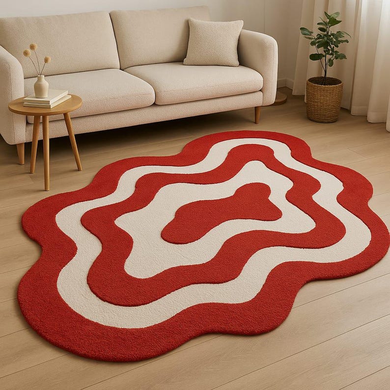 Hand-tufted bold red and white abstract rug with irregular amoeba shape and sculptural wavy layers. Modern retro design perfect for living rooms, bedrooms, or artistic spaces. Handmade custom wool rug adds visual interest and a fun pop of color to minimalist or boho interiors. Soft, cozy, and durable area rug ideal for under coffee tables or sofas. Unique sculpted carpet designed to elevate home decor with a bold and stylish statement.