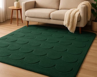 May include: A dark green rug with a textured pattern of overlapping half-circles. The rug is made of a soft, plush material.