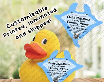 May include: A yellow rubber duck with a blue dolphin-shaped tag hanging from its neck. The tag has the text "Cruise Ship Name", "Cruising Dates", "Family Name", "Hometown, State", and "conQUACKulations".