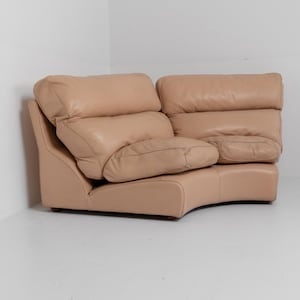 May include: A set of three ceramic mugs with a speckled, cream-colored glaze. Each mug features a different hand-painted design: a blue and green leaf, a yellow flower, and a red berry. The mugs have a simple, rounded shape.