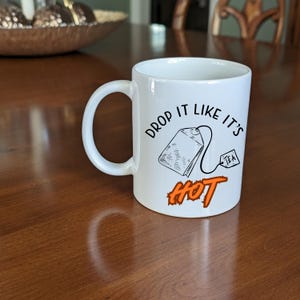 Drop It Like it&#39;s Hot Funny Tea Mug, White Ceramic, 11oz. Coffee Cup with Saying, Gift for Tea Lover - Mother - Grandmother, Hilarious Mug