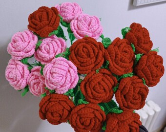 May include: A bouquet of crocheted roses in shades of pink and red. The roses are arranged in a circular pattern and have a realistic appearance.