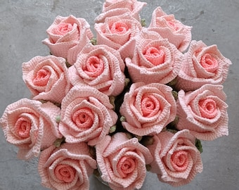 May include: A bouquet of crocheted pink roses. The roses are arranged in a circle and have a realistic appearance.