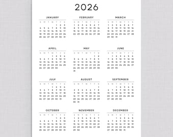 May include: A minimalist 2026 calendar printed on white paper. Each month is displayed with a simple, black font, showing the days of the week and dates. The year "2026" is at the top.