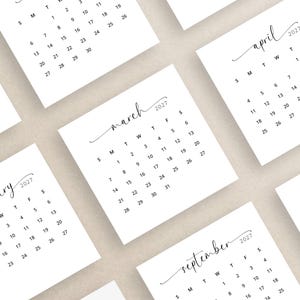 May include: White square calendars for the year 2027, with months like February, March, April, September, and October. Each calendar features a minimalist design with black text and a cursive month name.