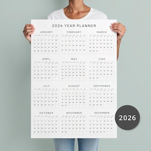 May include: A black and white printable 2026 year planner with a simple design. The calendar is divided into 12 months, with each month displayed in a separate box. The months are listed in order from January to December. The calendar is perfect for planning and organizing your year.