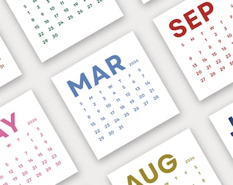 May include: A collection of square 2026 calendars, each displaying a different month. The months are printed in various colors, including blue, red, and green, against a white background. The calendars are arranged at different angles.