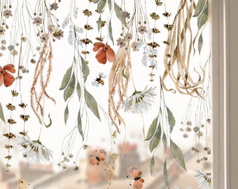 May include: A window with a floral design featuring delicate watercolor flowers, leaves, and butterflies. The design is in shades of brown, green, and white, and it appears to be a decal or sticker.