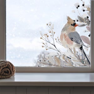 Könnte beinhalten: Ein Fensteraufkleber mit einer gemalten Illustration eines Haubenvogels, der auf einem Zweig mit Beeren und Blättern sitzt. Der Vogel hat ein graues, beiges und rosafarbenes Gefieder mit einem leuchtend orangefarbenen Schnabel auf einer Glasscheibe.