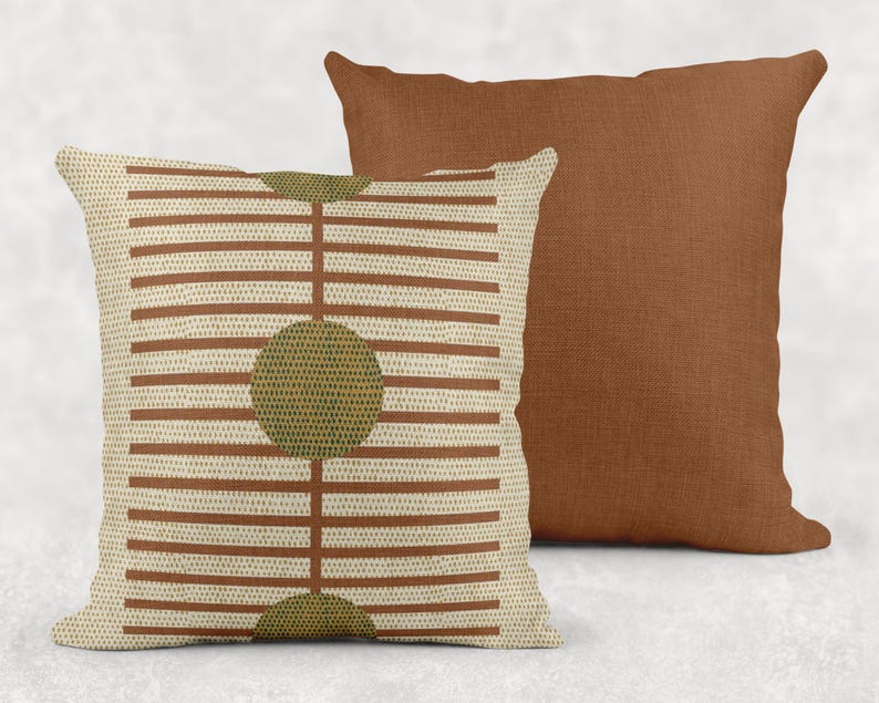 two throw pillows, one with a striped pattern and the other with a solid color.