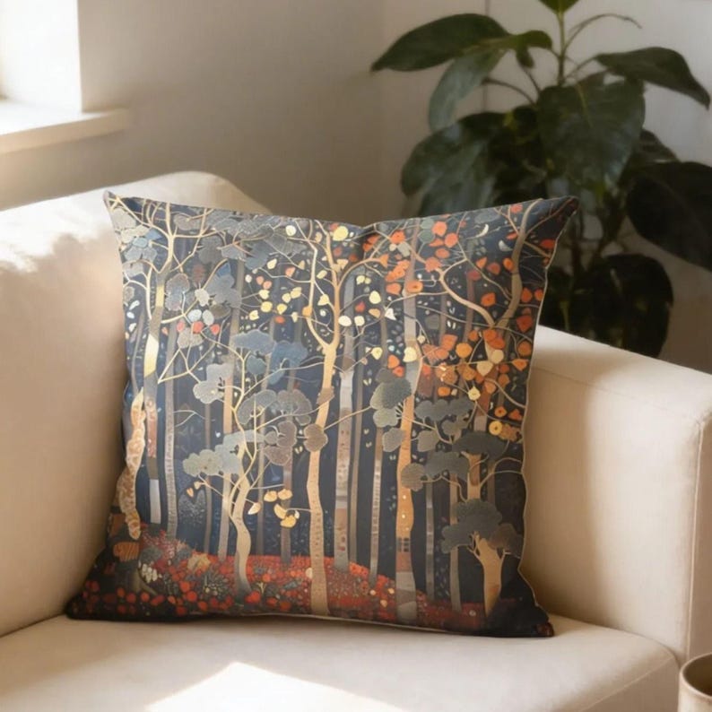 a cozy living room with a white sofa, a decorative pillow with a forest scene, a coffee table with a book and a mug, and a potted plant in the corner.