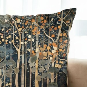 a close-up view of a decorative pillow with a detailed forest scene design.