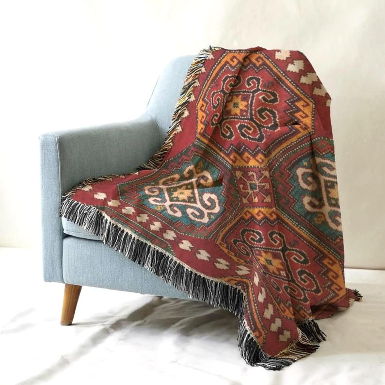 A vibrant, patterned throw blanket is draped over the armrest of a light blue armchair, creating a cozy and inviting atmosphere.